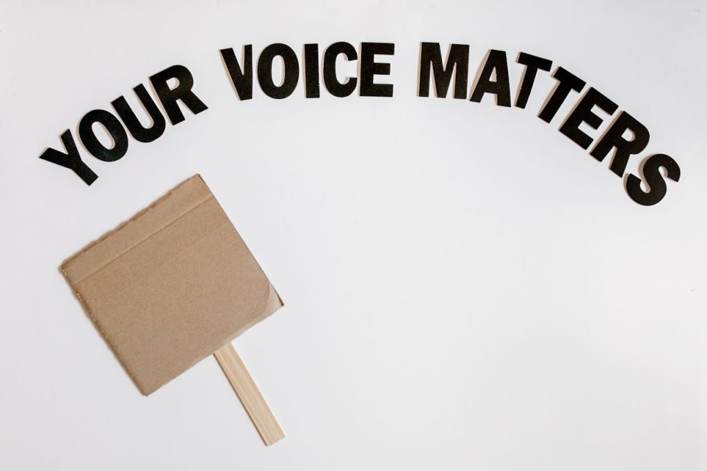 Cardboard protest sign with text Your Voice Matters emphasizes empowerment and advocacy.